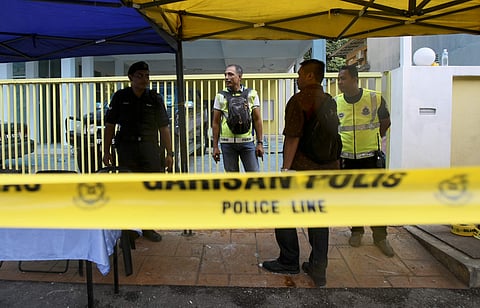 Police officers guard the entrance outside a religious school following Thursday's fire on the outskirts of Kuala lumpur, Malaysia on Sept. 15, 2017. (Photo | AP)