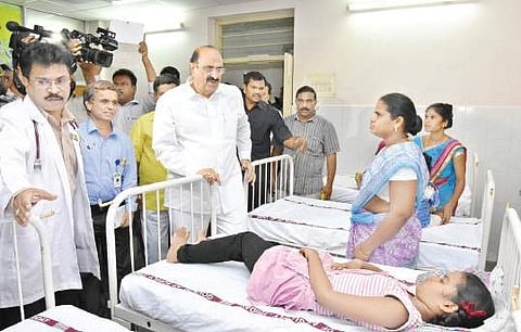 Health Minister Kamineni Srinivas enquiring about the health condition of kids at SVR Ruia Hospital in Tirupati on Friday | Express