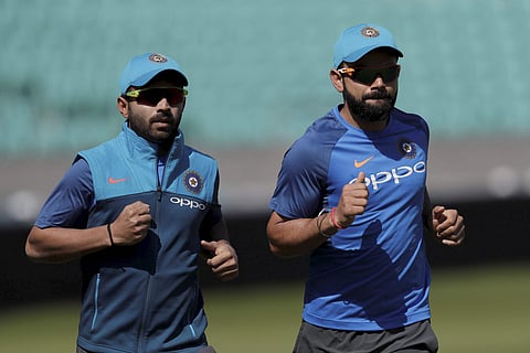 Captain Virat Kohli (R) might consider giving Ajinkya Rahane, who is yet to get a chance in the ongoing tournamnet when India face Sri Lanka tomorrow (File | AP)