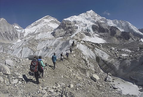 International trekkers pass through a glacier at the Mount Everest base camp, Nepal. (Photo | AP)