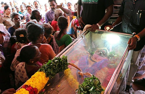 Family and members of the public pay their last respects to Anitha as the final rites are being performed
