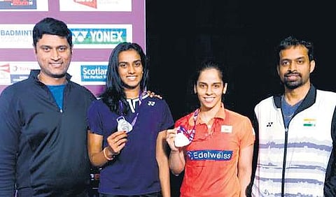 Saina Nehwal (2nd R) and Pullela Gopichand (R) during the World Championships. | File Photo