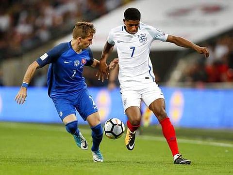 England's Marcus Rashford and Slovakia's Peter Pekarik, from right, challenge for the ball during the World Cup Group F qualifying soccer match at Wembley Stadium in London. | AP