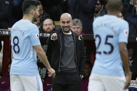 Manchester City manager Pep Guardiola looks across the pitch during the English Premier League soccer match between Crystal Palace and Manchester City at Selhurst Park in London, Sunday Dec. 31, 2017. | AP