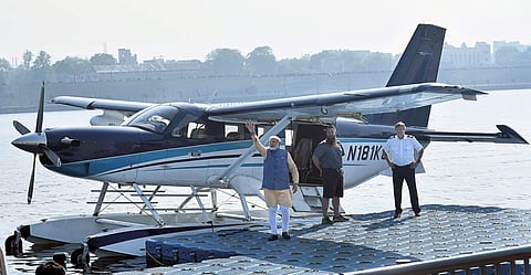 Prime Minister Narendra Modi waves to the crowd as he boards a seaplane on the Sabarmati river front in Ahmedabad. (File | PTI)