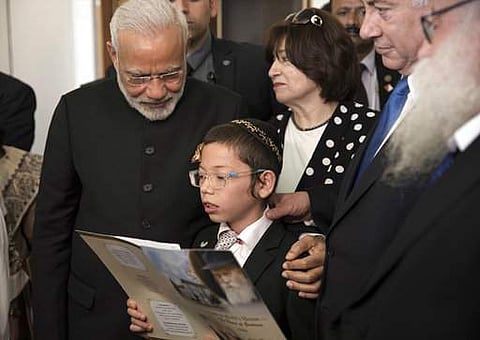 Indian Prime Minister Narendra Modi, left, with Israeli Prime Minister Benjamin Netanyahu, second right, meet with with Moshe Holtzberg, center, an Israeli boy, whose parents were killed in the Nov. 26, 2008 terrorist attack on the Mumbai Chabad House, at