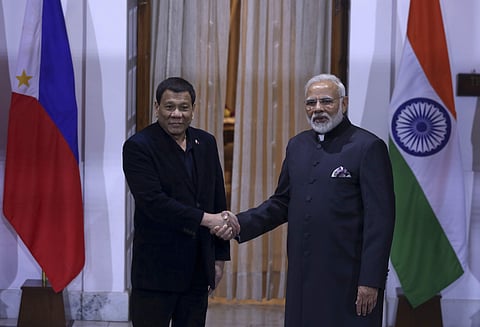 Philippine President Rodrigo Duterte, left and Indian Prime Minister Narendra Modi pose for the media ahead of their meeting in New Delhi. | AP