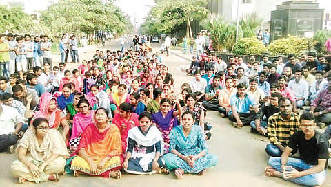 JNTUK students staging a protest in Kakinada on Tuesday demanding action against Prof K Babulu | Express