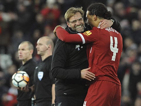 Liverpool manager Juergen Klopp, left, congratulates winning goal scorer Liverpool's Virgil van Dijk after the final whistle during the English FA Cup Third Round soccer match between Liverpool and Everton at Anfield. | AP