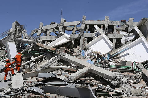 Indonesian rescue team inspect the damage of Roa-Roa Hotel following a massive earthquake and tsunami in Palu, Central Sulawesi, Indonesia, Monday, Oct. 1, 2018. A mass burial of earthquake and tsunami victims was being prepared in a hard-hit city Monday