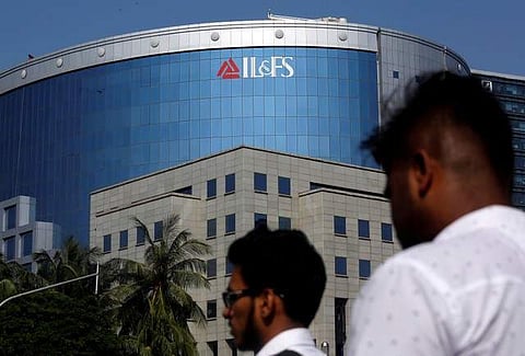 People walk past a building of IL&FS (Infrastructure Leasing and Financial Services Ltd.) outside its headquarters in Mumbai, India, September 25, 2018. (Photo: File / Reuters)