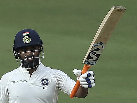 Rishabh Pant raises his bat after completing his half-century. (Photo | AP)