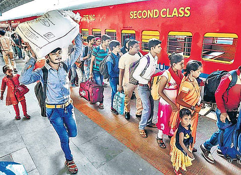 Migrant workers from Uttar Pradesh and Bihar board a train at Ahmedabad station to go back to their home states in the wake of attacks on them in Gujarat | PTI