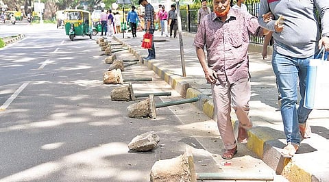 Blocks of concrete attached to iron poles placed along the road to prevent parking of vehicles | Nagaraja Gadekal