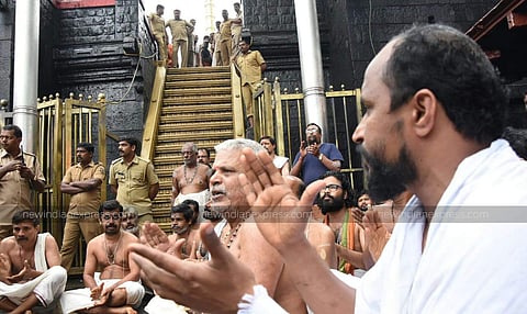 Sabarimala temples aides at the foot of the 18 steps of the hill shrine protesting against the two women who attempted to enter Sabarimala hill shrine on October 19, 2018. (Photo | BP Deepu/ EPS)
