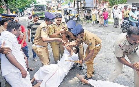 Police removing the Youth Congress members who laid seige to the Palarivattom- Kakkanad road A Sanesh