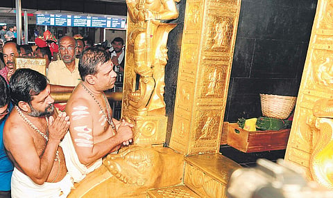 Newly appointed Sabarimala melsanthi V N Vasudevan Namboothiri and Malikappuram melsanthi M M Narayanan Namboothiri pray in front of the sanctum sanctorum of Sabarimala Lord Ayyappa temple on Sunday | Express
