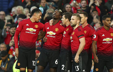 Manchester United's Paul Pogba (SL) celebrates after scoring the opening goal during the English Premier League match against Everton | AP