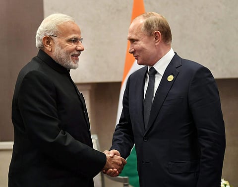 Prime Minister Narendra Modi shakes hands with Russian President Vladimir Putin. (PIB Photo)