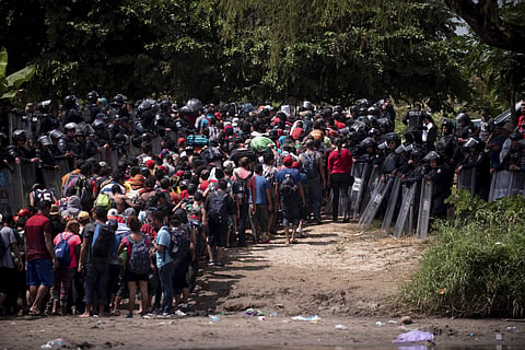 The first group was able to cross the river on rafts — an option now blocked by Mexican Navy river and shore patrols. The police allowed the passage of the migrants. (Photo | AP)