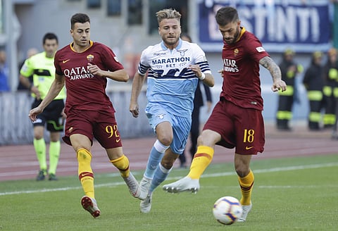 Lazio's Ciro Immobile, center, is challenged by Roma's Stephan El Shaarawy, left, and Davide Santon during the Serie A soccer match between Roma and Lazio, at the Rome Olympic Stadium, Saturday, Sept. 29, 2018. | AP