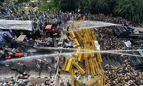 Police use water cannons to disperse farmers protesting at Delhi-UP border during 'Kisan Kranti Padyatra' in New Delhi Tuesday Oct 2 2018. (Photo | PTI)