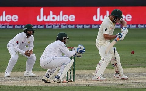 Australian cricketer Aaron Finch (R) plays a shot during day two of the first Test match in the series between Australia and Pakistan in Dubai on October 8, 2018. | AFP