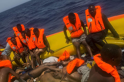 African migrants wait to be rescued by aid workers from the Spanish NGO Proactiva Open Arms next to the bodies of other migrants in the Mediterranean Sea (File | AP)