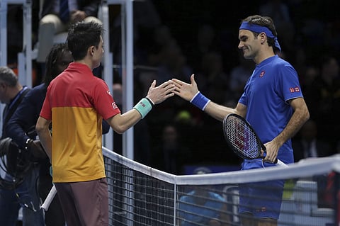 Japan's Kei Nishikori shakes hands with Switzerland's Roger Federer after Nishikori won their ATP World Tour Finals singles final tennis match at the O2 Arena in London. (Photo | AP)