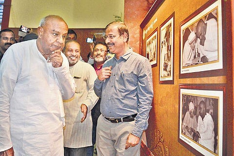 Former PM H D Deve Gowda looks at rare pictures of his early days in politics at Ravindra Kalakshetra in Bengaluru on Saturday | Pushkar V