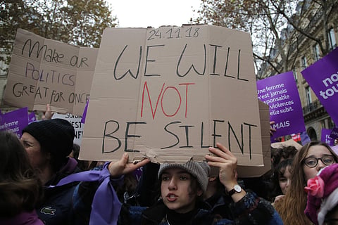 A woman demonstrates against violence against women Saturday, Nov. 24, 2018 in Paris. French feminists have set Nov. 24 as a day for nationwide marches to protest violence against women. (AP Photo/Michel Euler)