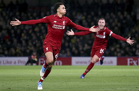 Liverpool's Trent Alexander-Arnold, left, celebrates scoring his side's second goal of the game with a free kickduring their English Premier League soccer match against Watford at Vicarage Road, Watford, England, Saturday, Nov. 24, 2018. | AP