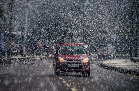 A vehicle moves during season's first snowfall in Srinagar Saturday Nov 3 2018. | PTI