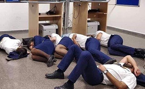 The Ryanair flight crew were seen getting into a position on the floor for the snap. After the picture was taken, the staffers got up and walked away. (Photo | Twitter)