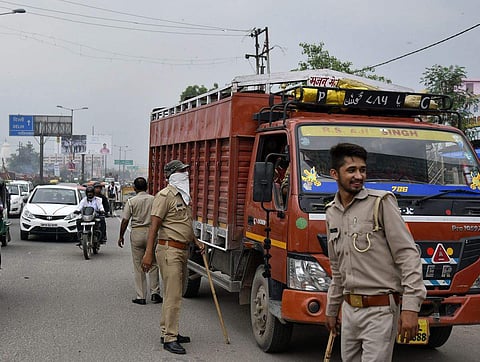 Police officers check commercial vehicles for customs purposes (Photo | Anindito Mukherjee/Bloomberg)