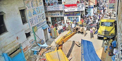 BBMP officials remove illegal shops on the footpath at SP Road on Saturday | Pushkar V