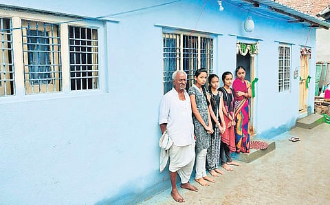 Sujatha with her daughters standing in front of her newly constructed house in Jagtial (Photo | Express)