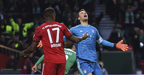 Bayern Munich goalkeeper Manuel Neuer reacts besides team mate Jerome Boateng after Bremen's Yuya Osako scored his side's opening goal during the German Bundesliga match in Bremen, Germany | AP