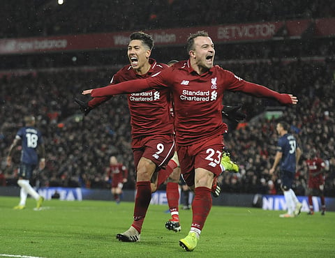 Liverpool's Xherdan Shaqiri (R) celebrates after scoring his side's third goal during the English Premier League match against Manchester United (Photo | AP)