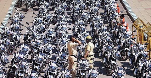 Police personnel wait for the Chief Minister to flag off 911 police patrol bikes at Vidhna Soudha on Wednesday | Pushkar V