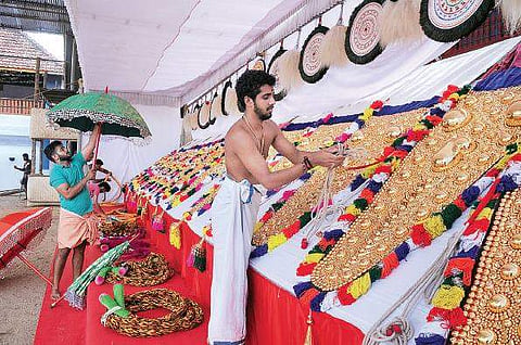 Temple authorities giving final touches to 'aanachamayam’ ahead of the Vrischikolsavam at Sree Poornathrayeesa Temple. (Below) Shops set up ahead of the festival A Sanesh