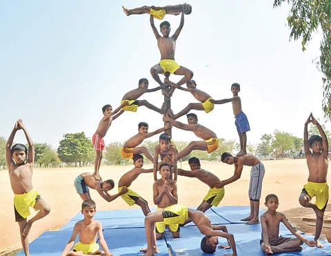 Students from Group Pyramid performing Mallakhamba | D Hemanth