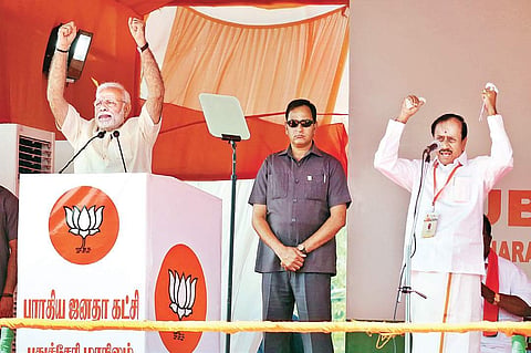 Prime Minister Narendra Modi addressing a public meeting in Puducherry on Sunday, as BJP national general secretary H Raja translates his speech | G PATTABIRAMAN