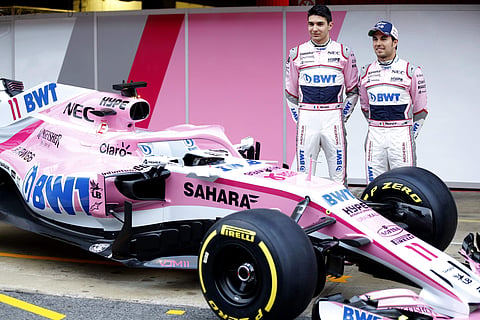 Force India drivers Sergio Perez of Mexico, right, and Esteban Ocon of France pose for photos during the Force India team official presentation at the Catalunya racetrack in Montmelo, outside Barcelona, Spain, Monday, Feb. 26, 2018. | AP