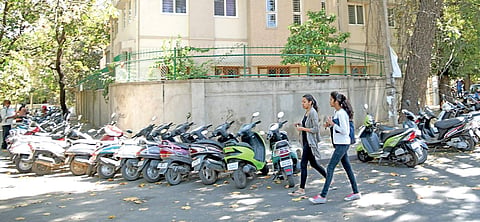 Students of Mount Carmel College park their vehicles by roadside on Palace Loop Road Nagaraja Gadekal