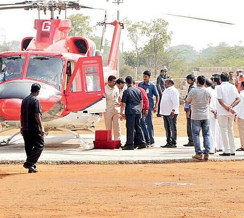 Security personnel removing the bag that caught fire in KCR’s chopper in Karimnagar on Tuesday | Express photo