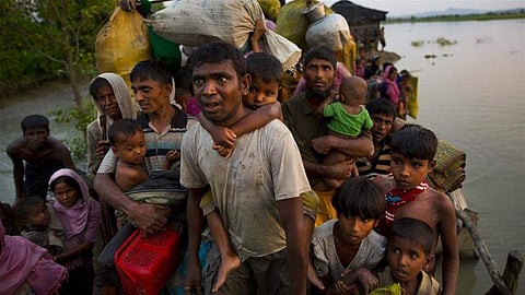 Rohingya Muslims carry their children and belongings after crossing the border from Myanmar into Bangladesh in November (File | Associated Press)