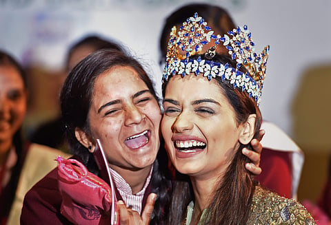 Manushi Chhillar with a young girl during a menstrual hygiene awareness event | PTI Photo