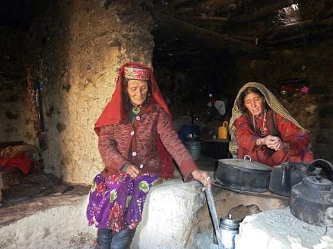 This photograph taken on October 8, 2017 shows Afghan Wakhi nomadic woman Sultan Begium (L) and her daughter-in-law preparing food inside their mud home in the Wakhan Corridor in Afghanistan. (Photo | AFP)