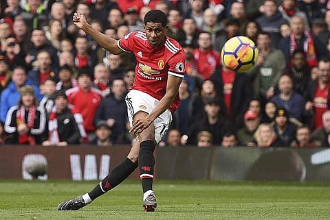 Manchester United's English striker Marcus Rashford scores the opening goal during the English Premier League football match between Manchester United and Liverpool at Old Trafford in Manchester. | AFP